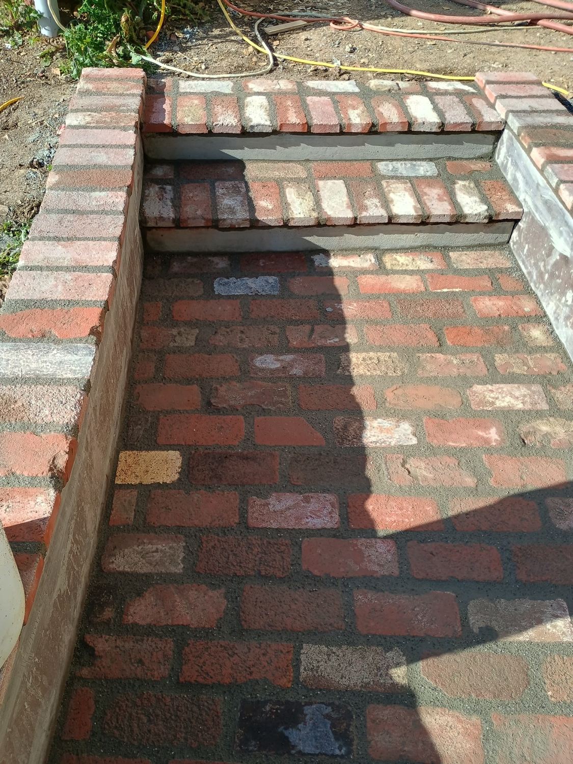 Detailed brick masonry steps and landing.